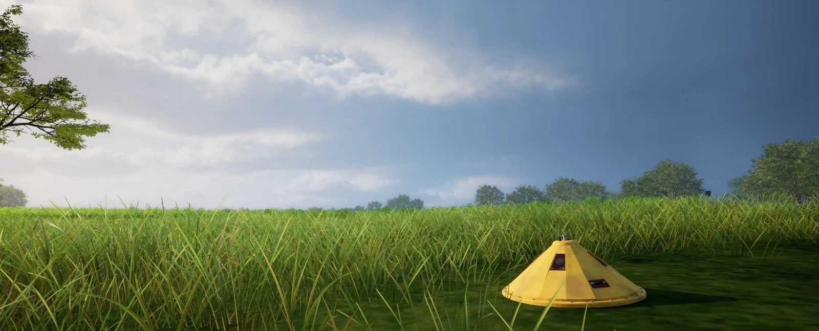 A yellow weather probe deployed in tall grass under a partly clouded sky